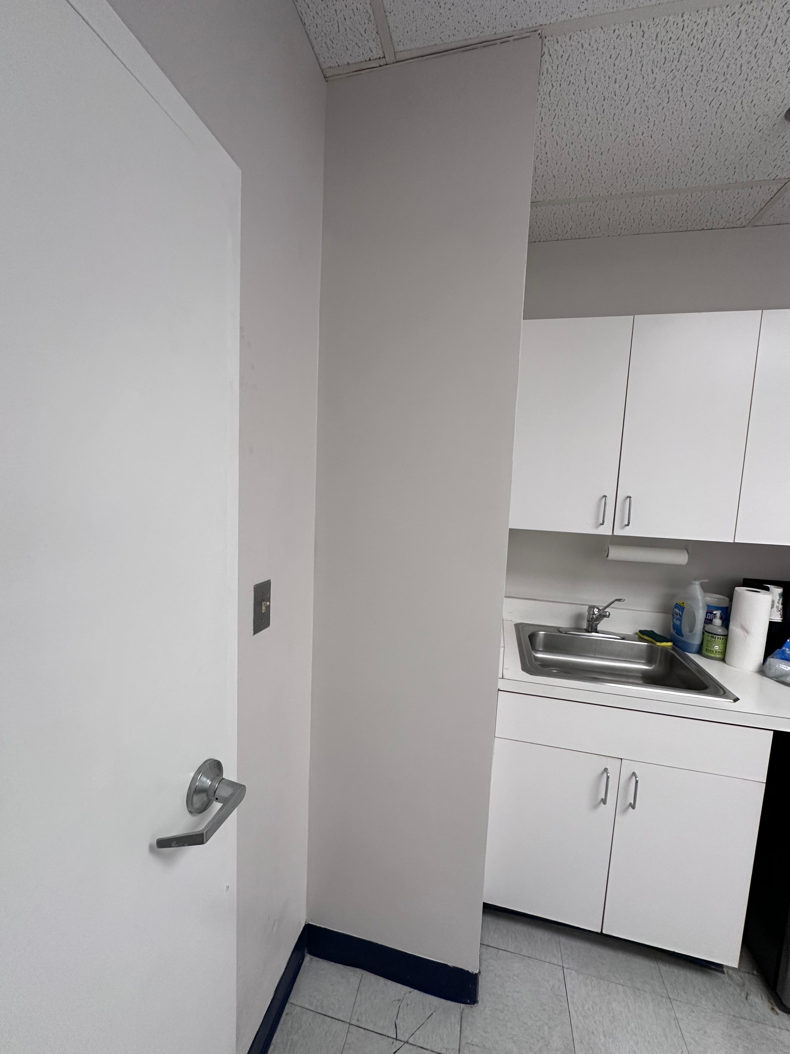 Pipe chase wall repaired and painted after drywall work